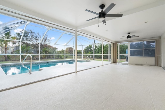 view of pool with ceiling fan, glass enclosure, and a patio area