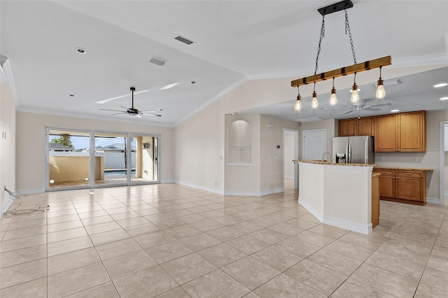 kitchen with pendant lighting, stainless steel fridge, light tile patterned flooring, and vaulted ceiling