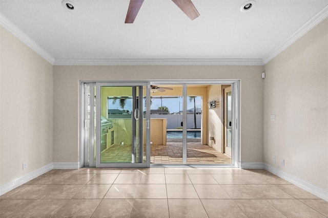 spare room featuring light tile patterned floors, ceiling fan, and ornamental molding