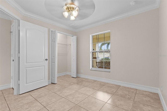 unfurnished bedroom with ceiling fan, ornamental molding, light tile patterned floors, and a closet