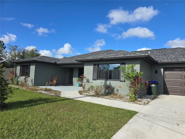 view of front of property with a garage and a front yard