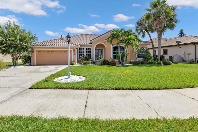 mediterranean / spanish-style home featuring a front lawn and a garage