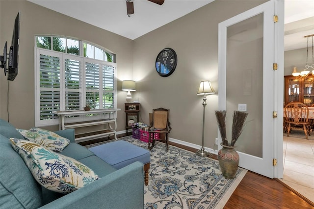 2388 Silver Palm Rd, North Port, FL 34288 - living room featuring a chandelier, a ceiling fan, and wood finished floors