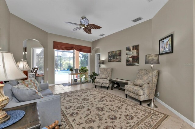 2388 Silver Palm Rd, North Port, FL 34288 - living area featuring arched walkways, a ceiling fan, and light tile patterned floors