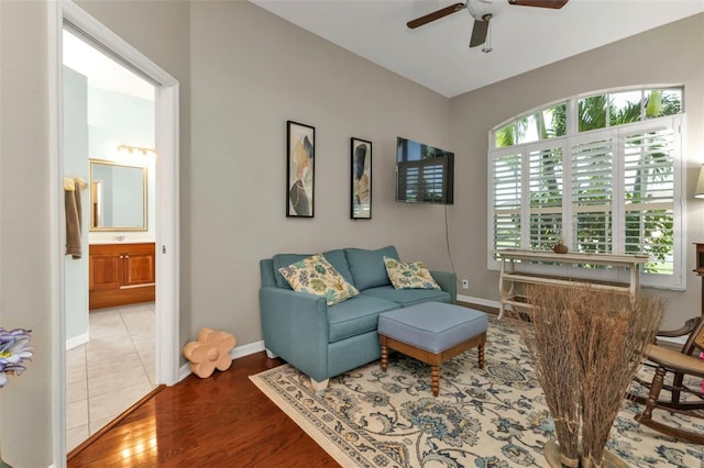 living room featuring hardwood / wood-style floors and ceiling fan