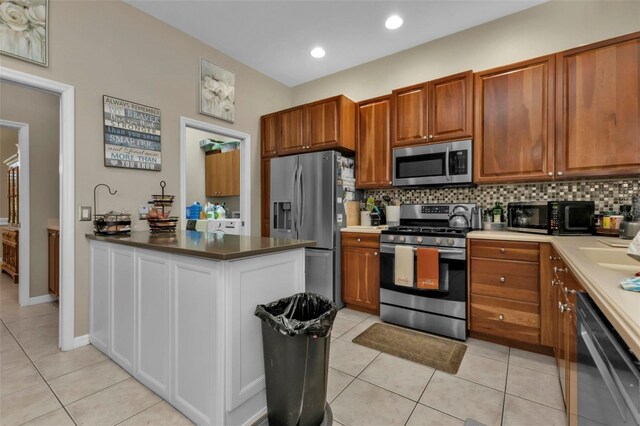 2388 Silver Palm Rd, North Port, FL 34288 - kitchen featuring stainless steel appliances, light tile patterned floors, a peninsula, tasteful backsplash, and recessed lighting