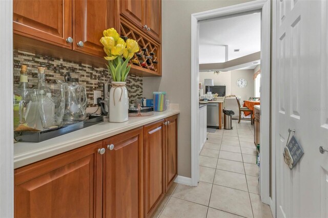 2388 Silver Palm Rd, North Port, FL 34288 - bar area featuring light tile patterned floors, decorative backsplash, and dishwasher