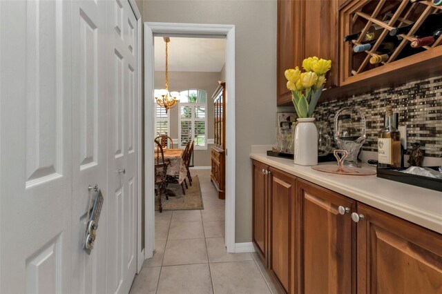 2388 Silver Palm Rd, North Port, FL 34288 - hallway featuring a chandelier and light tile patterned floors