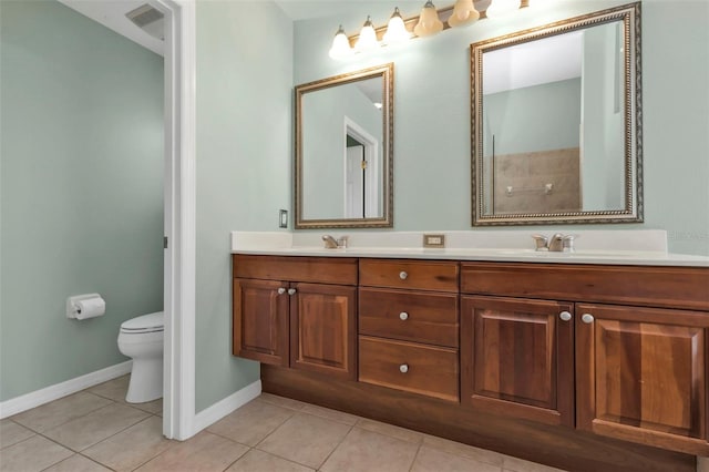 bathroom featuring tile patterned floors, vanity, and toilet