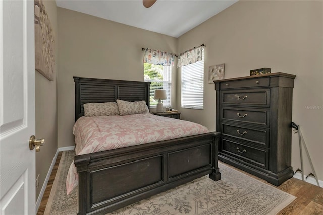 bedroom with ceiling fan and light hardwood / wood-style flooring