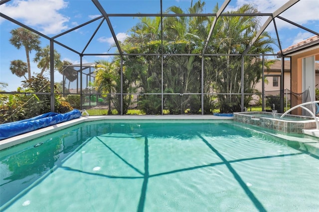 view of swimming pool with glass enclosure and an in ground hot tub