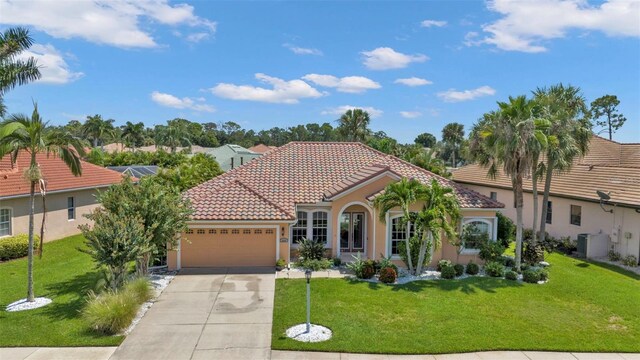 2388 Silver Palm Rd, North Port, FL 34288 - mediterranean / spanish house featuring a garage, a tiled roof, concrete driveway, and stucco siding