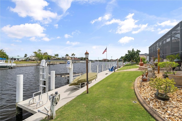 view of dock featuring a lanai, a yard, and a water view