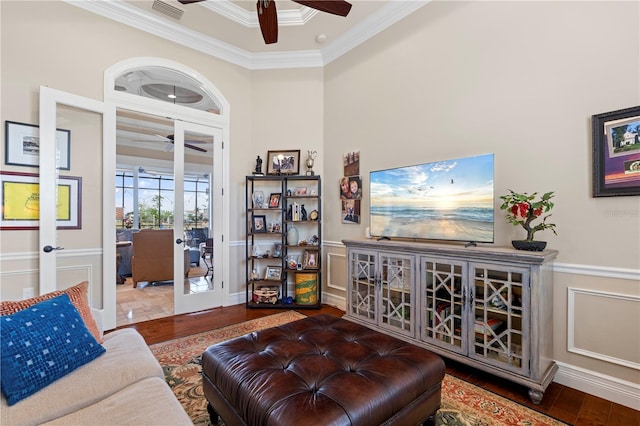 living room with ceiling fan, french doors, a high ceiling, crown molding, and wood-type flooring