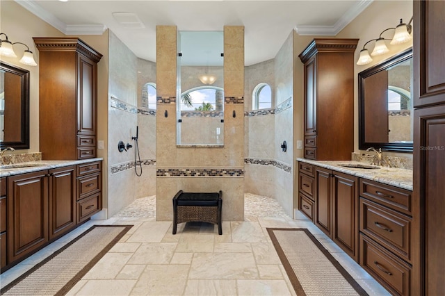 bathroom featuring vanity, ornamental molding, and tiled shower