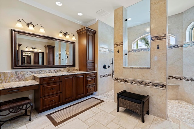 bathroom featuring a tile shower, tile walls, and crown molding