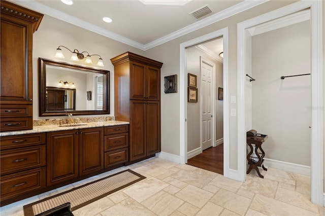 bathroom with vanity and ornamental molding