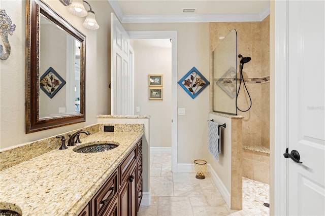 bathroom featuring vanity, a tile shower, and crown molding