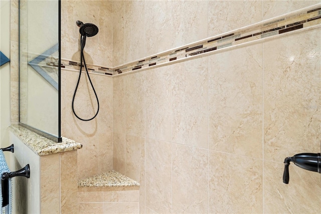 bathroom with a tile shower