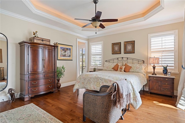 bedroom featuring ornamental molding, ceiling fan, a raised ceiling, and light hardwood / wood-style floors