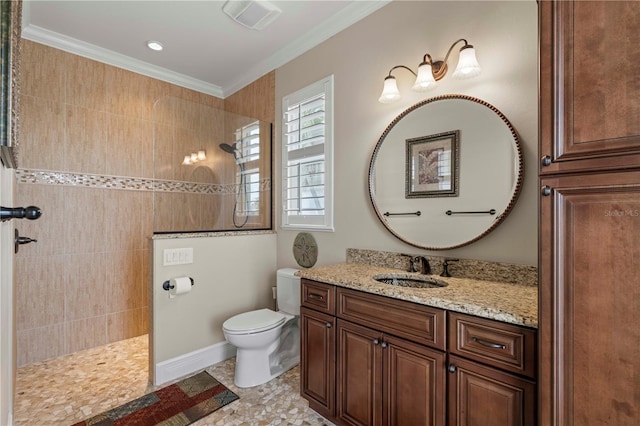 bathroom with vanity, ornamental molding, toilet, and tiled shower