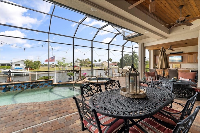 exterior space with a water view, ceiling fan, and a lanai