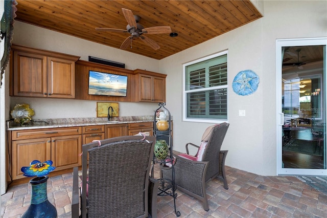 view of patio / terrace with ceiling fan and sink