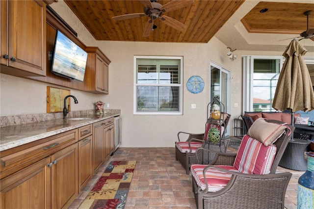 view of patio featuring ceiling fan and sink