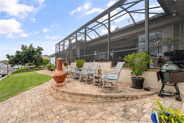 view of patio with glass enclosure and grilling area