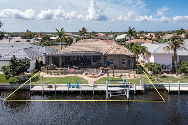 exterior space featuring a water view, a patio area, a lanai, and a lawn