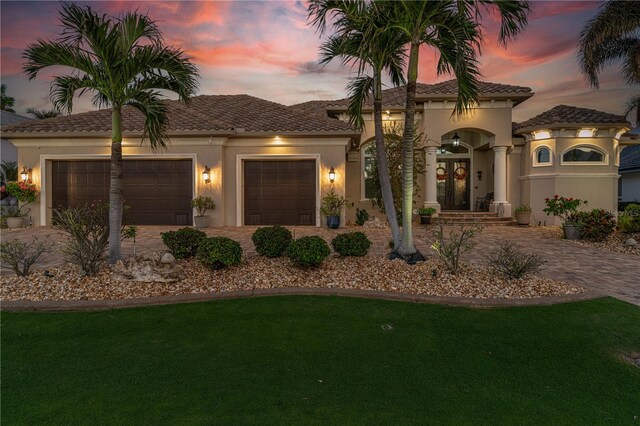 mediterranean / spanish-style house with a garage