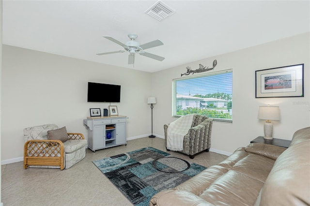 living room with ceiling fan and light tile patterned floors