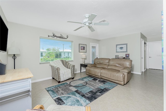 tiled living room featuring ceiling fan