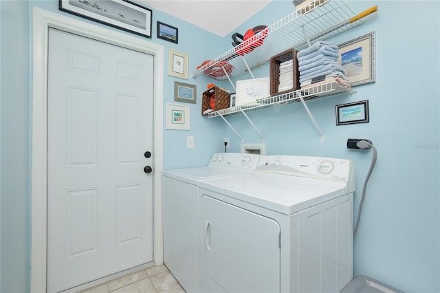 laundry room with light tile patterned flooring and independent washer and dryer