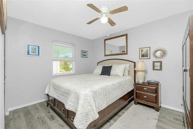 bedroom with ceiling fan and light hardwood / wood-style flooring