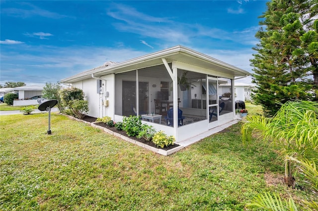 exterior space featuring a sunroom and a yard