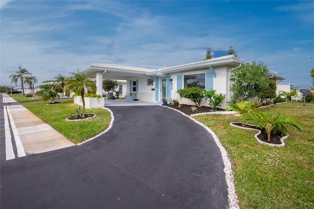 ranch-style home featuring a front yard