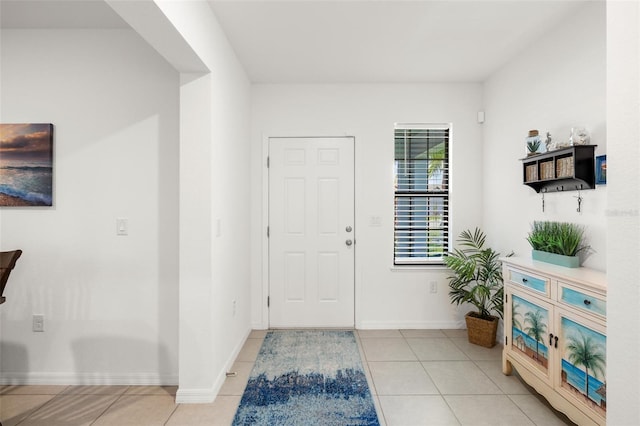 foyer entrance with light tile patterned flooring