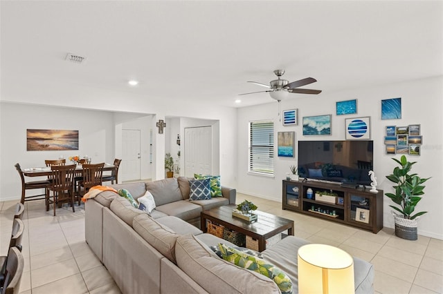 tiled living room with ceiling fan