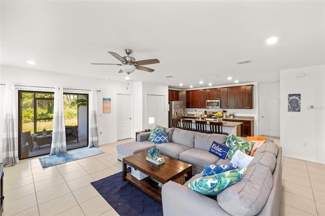 tiled living room featuring ceiling fan