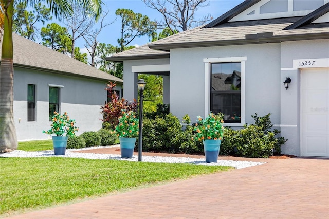 doorway to property featuring a lawn