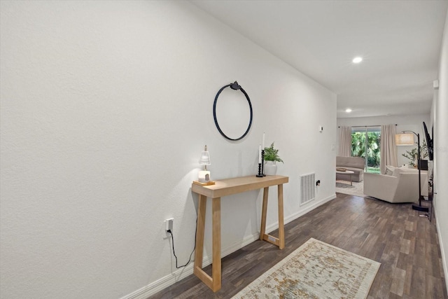 corridor featuring dark wood-type flooring