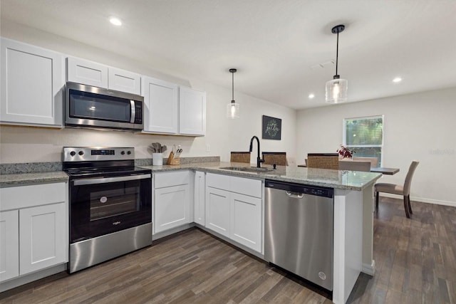 kitchen with white cabinetry, appliances with stainless steel finishes, hanging light fixtures, and sink