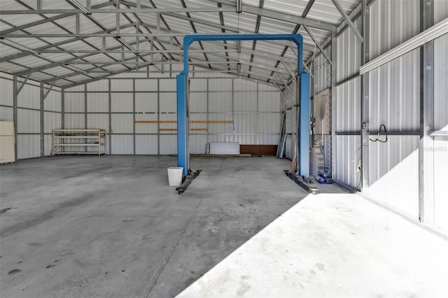 garage with metal wall and freestanding refrigerator