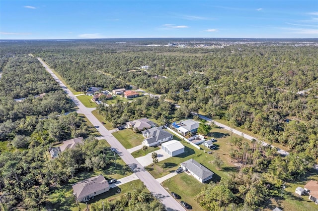 birds eye view of property featuring a wooded view