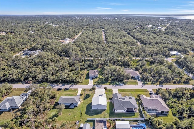 bird's eye view featuring a residential view and a wooded view