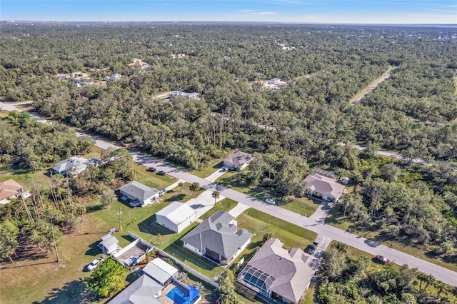 drone / aerial view featuring a view of trees