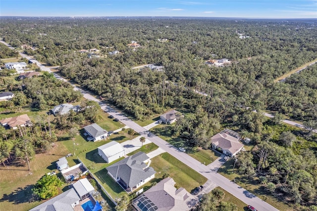 birds eye view of property featuring a residential view and a view of trees