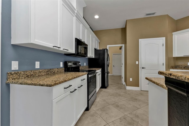 kitchen featuring stainless steel range with electric stovetop, light tile patterned floors, white cabinetry, and dark stone countertops