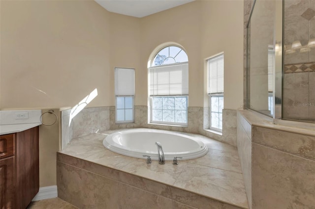 bathroom with a bath and tiled shower